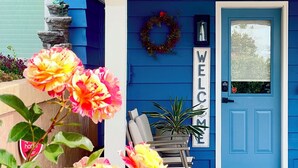 A blue house with a 'WELCOME' sign, a doorbell, and a chair outside. - 1400sft Spacious SeaView Retreat & Garden surround (Federal Way)