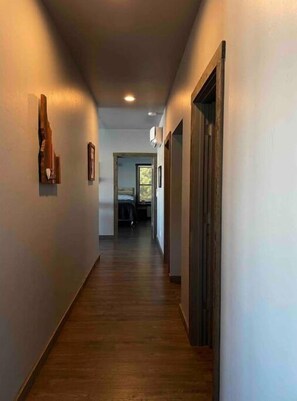 Enter a serene bedroom with a comfortable bed and natural light pouring in through the window.