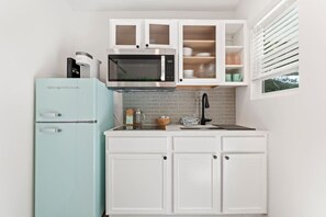 Fridge, microwave, coffee/tea maker, cookware/dishes/utensils