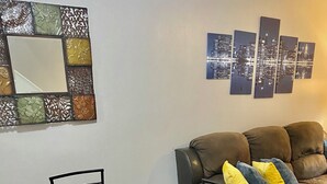 A dining area with a wooden table and chairs, a small plant on the table, and a sofa with cushions in the background. - Beautiful & Stylish 2 BR & 2.5 Baths 10min downtown, 5min Lexington Med Center (Columbia)