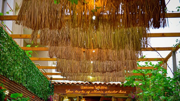A thatched roof structure with a sign reading "Welcome to Tembuto." - Te Bujtina Hotel&Restaurant (Golem)