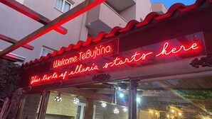 A neon sign welcoming visitors to TeBujtina, indicating the start of an all-inclusive experience. - Te Bujtina Hotel&Restaurant (Golem)