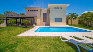 A modern two-story house with a swimming pool, a covered patio, and a well-maintained lawn. - 8 Bedroom Private Property (Sosua)