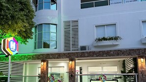 A hotel with a modern facade, large windows, and a visible entrance with a sign. - Hotel Zuriel Boutique (Cartagena)