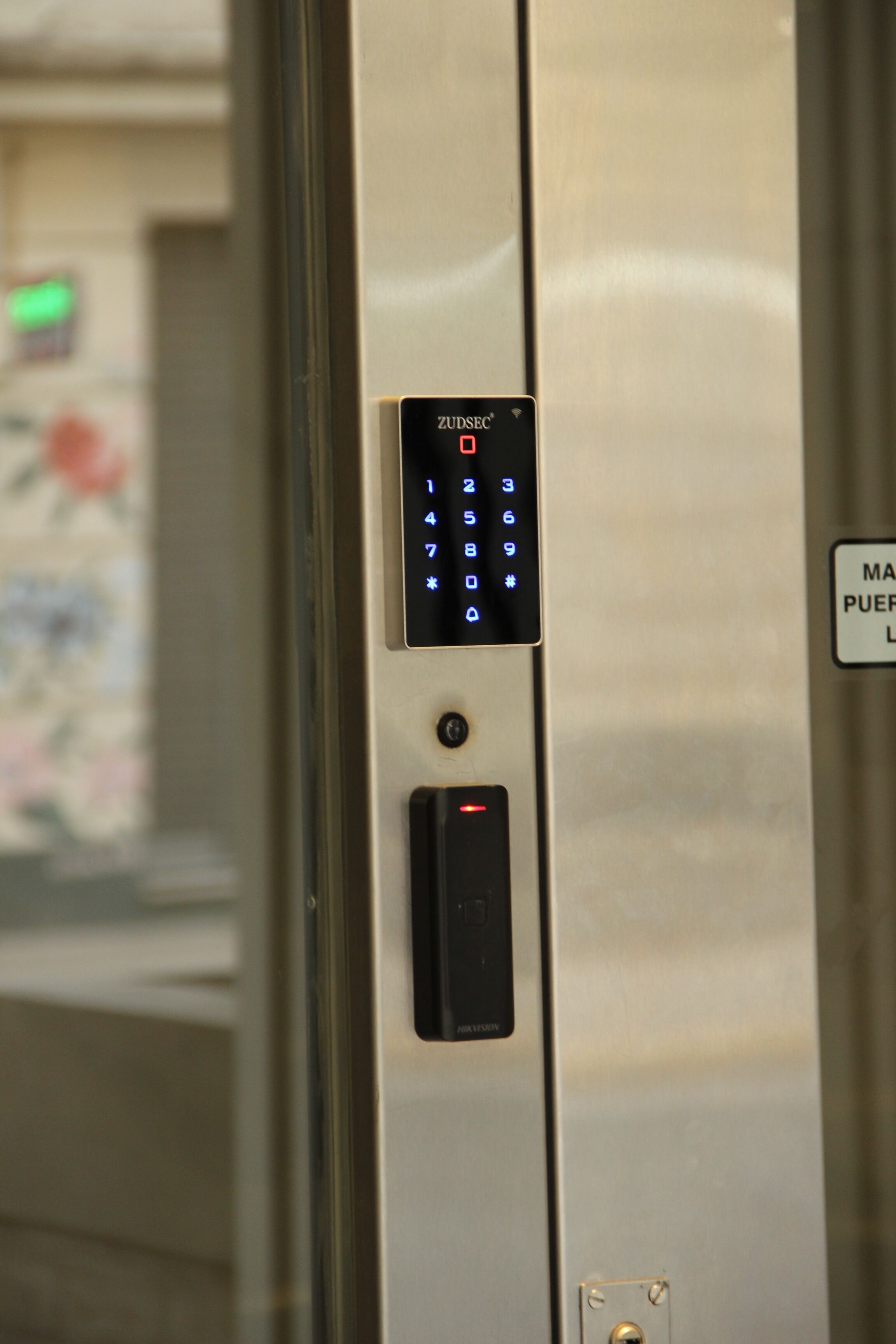 A keypad with a numeric keypad and a button below it, likely for elevator access.