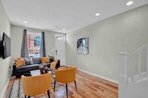 Relax in this stylish living room with a black leather sofa, armchair, and coffee table.