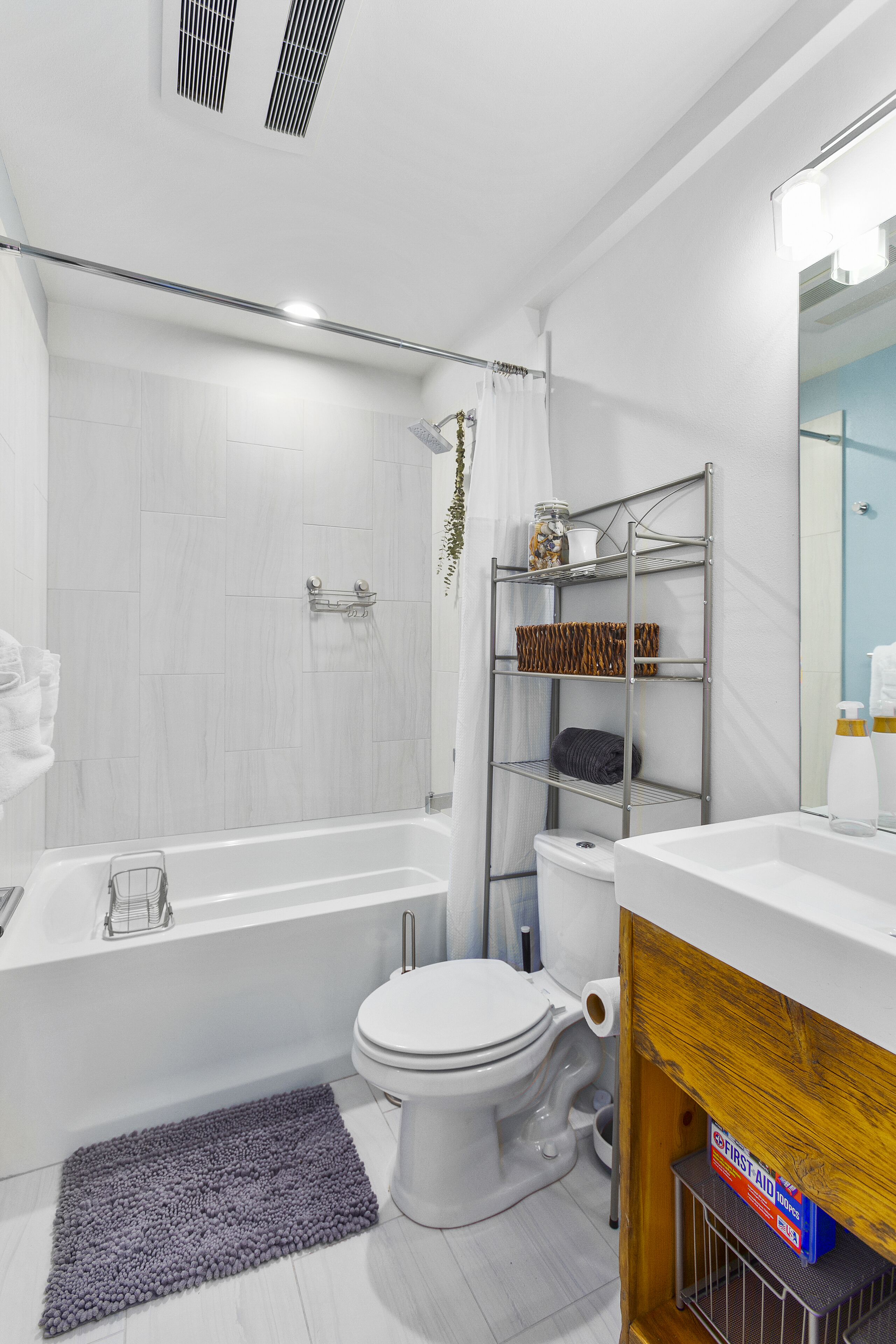 A modern bathroom with a bathtub, toilet, and shower area.