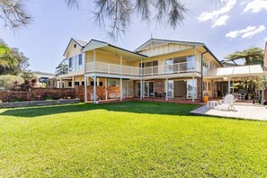Relax on the spacious balcony overlooking the well-maintained lawn.