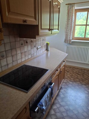 A kitchen with a stove, oven, and tiled backsplash.