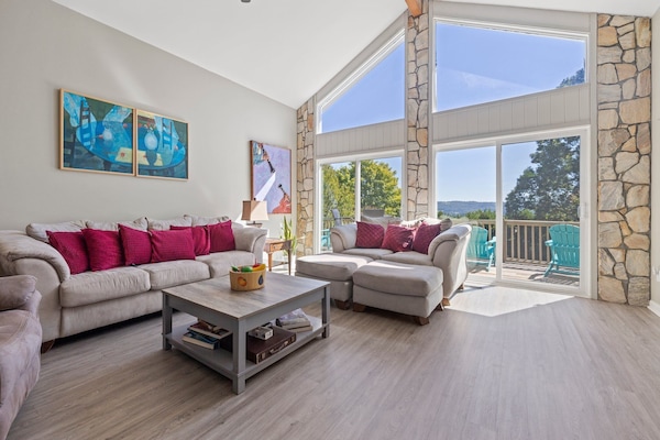 Living room, cathedral windows, original art work by owner.