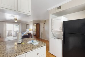 Enjoy cooking in this well-equipped kitchen with a granite countertop, washer and dryer, and ample cabinetry.