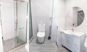 A modern bathroom with a glass shower enclosure, a toilet, and a sink with a mirror. - AWA Hotel (Rotorua)