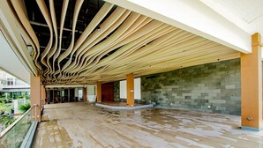 A spacious indoor area with a wooden ceiling and a tiled floor.