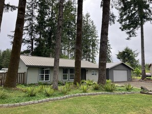 Exterior - Surrounded by trees, this 3-bedroom, fully stocked retreat sleeps 8. (Forks)