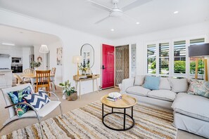 Relax in this inviting living space with a sofa, coffee table, and dining area.