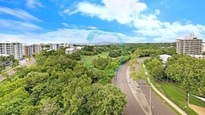 A residential area with a curved road, green spaces, and modern buildings. - ZEN LUXURY 2-STORY Penthouse Mindal View (Darwin)