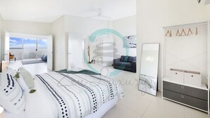 A modern bedroom with a large bed, a wardrobe, a mirror, and a balcony with a view. - ZEN LUXURY 2-STORY Penthouse Mindal View (Darwin)