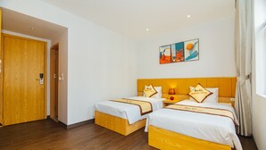 A hotel room with two beds, wooden headboards, white bedding, and a wooden floor. - MARUKO HOTEL HA LONG (Bai Chay)
