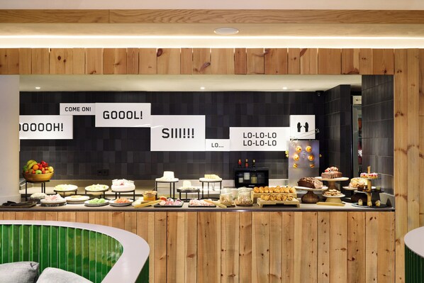 A buffet area with various food items and a sign with playful messages. - MIM Andorra Member of Meliá Collection (Escaldes-Engordany)
