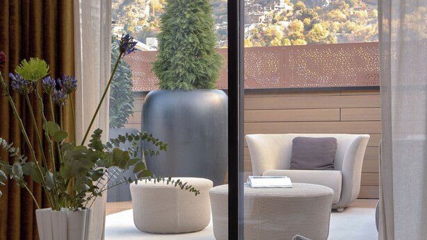 A modern room with a large sliding glass door leading to a balcony with a view of a mountainous landscape. - MIM Andorra Member of Meliá Collection (Escaldes-Engordany)