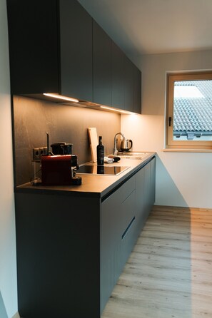Fridge, stovetop, dishwasher, coffee/tea maker