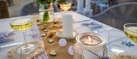 A table set for dining with candles, glassware, and heart-shaped decorations.