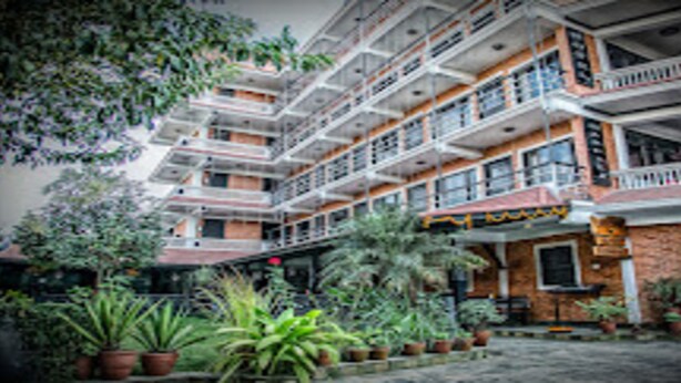A multi-story building with balconies, potted plants, and a sign that reads "Maya". - MeroStay 139 Hotel Mandala (Kathmandu)
