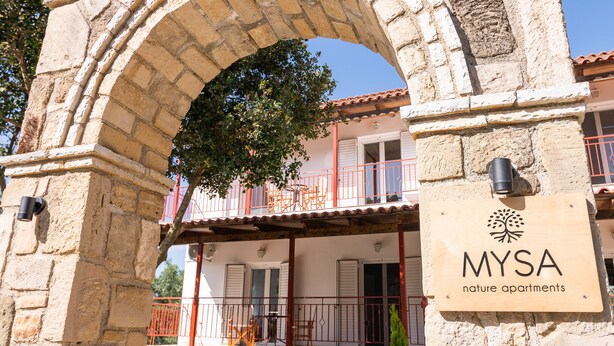 A stone archway leading to a building with a sign for "MYSA nature apartments". - Mysa Nature Apartments (Zakynthos)