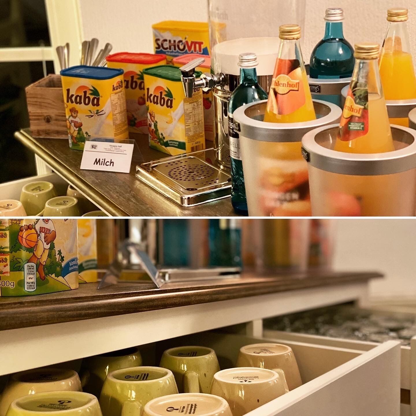 A beverage station with various drinks and containers, including a milk dispenser and a selection of bottles.