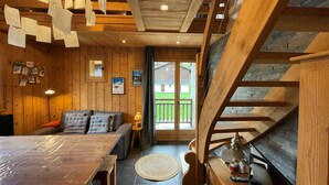 A cozy wooden interior with a sofa, table, and staircase. - Cozy duplex apartment 4 pers, parking (Crest-Voland)