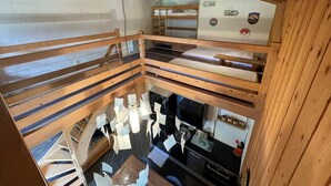 A multi-level wooden cabin with bunk beds, a kitchen area, and a dining space. - Cozy duplex apartment 4 pers, parking (Crest-Voland)