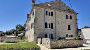 A stone building with multiple windows and a balcony. - Castello Gulich (Porec)