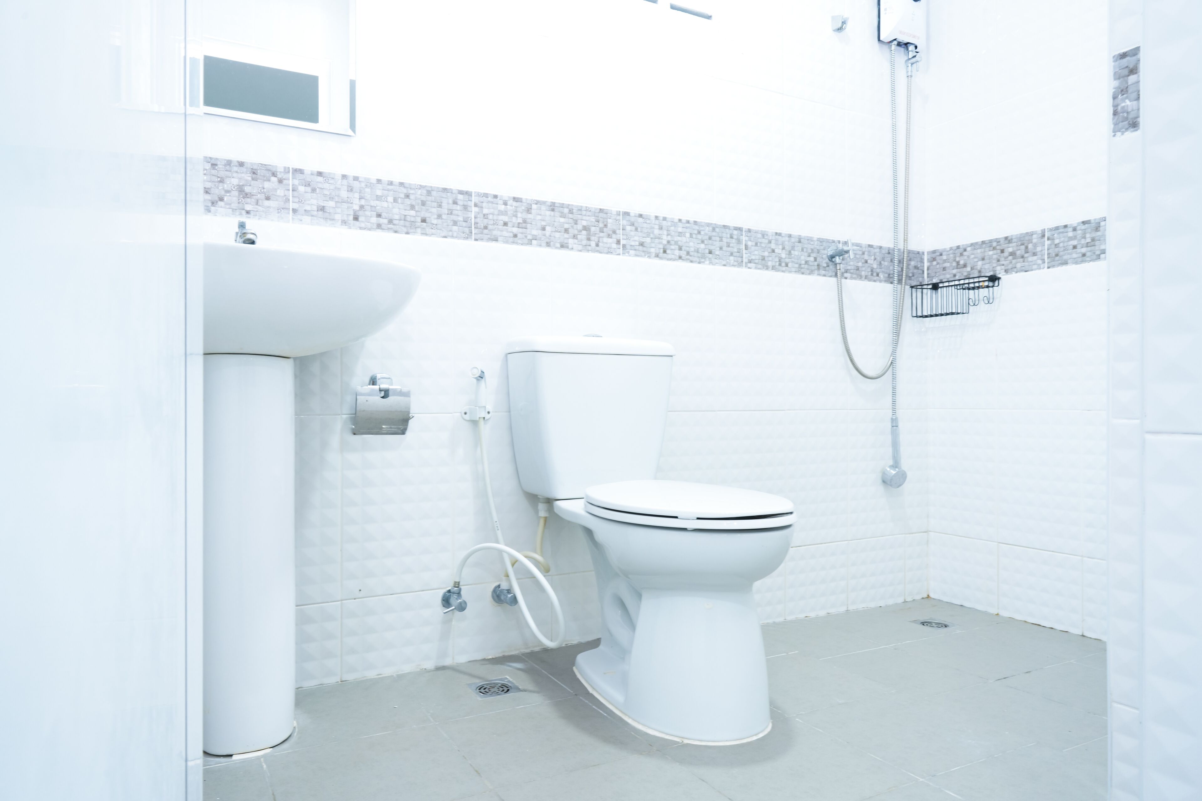 A modern bathroom with a toilet, sink, and shower.