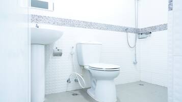 A modern bathroom with a toilet, sink, and shower.