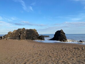 Enjoy the serene beach with rugged rock formations and access to the ocean.