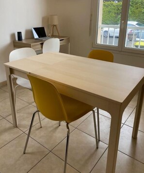 Enjoy meals in this dining area with a light-colored table and two chairs.