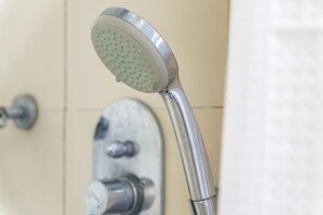 A showerhead with a circular design and multiple nozzles.