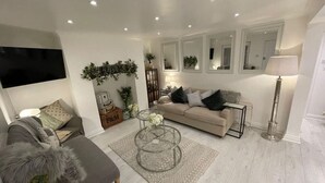 A modern living room with a sofa, coffee table, and floor lamp.