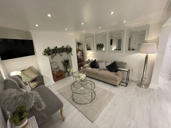 A modern living room with a sofa, coffee table, and floor lamp.