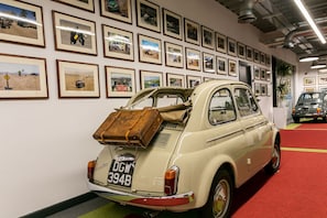 Vintage VW Beetle on display in a unique automotive exhibition space.