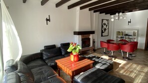 A modern living room with a sectional sofa, a coffee table, and a fireplace. - Casa Hemingway - Marbella Old Town (Marbella)