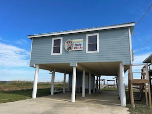 A two-story building with a sign that reads "Welcome to Pearly Whites."