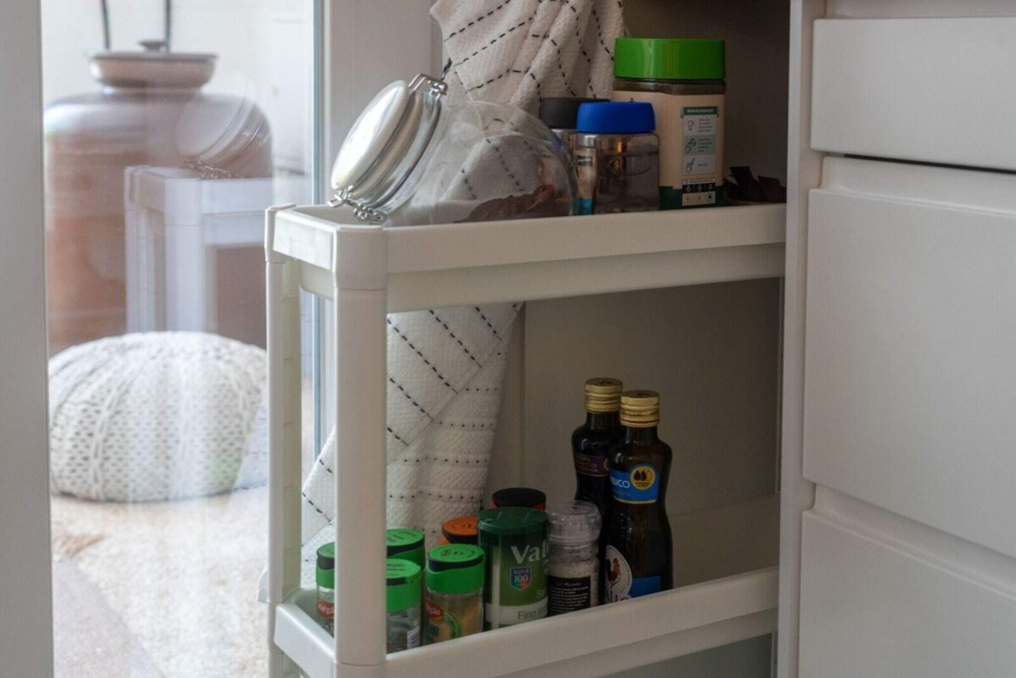 A white refrigerator with shelves containing various food items and condiments.