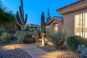 A desert garden with cacti and a building with a tiled roof and large windows. - 6BR Estate + Guest House, Pool & Spa (Scottsdale)