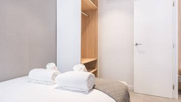 Enjoy a restful stay in this well-appointed room featuring a comfortable bed and convenient wardrobe.