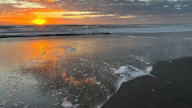 A beach with waves and a sunset. - The Cape (Brevard County)