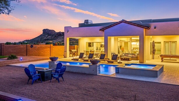 A modern house with a swimming pool, outdoor seating, and a mountain view. - An Arrow Escape! Views, Outdoor Games, Htd Pool & Spa (Gold Canyon)