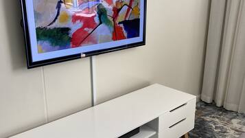 Grand Studio | Living area | 50-inch flat-screen TV with cable channels, TV, streaming services