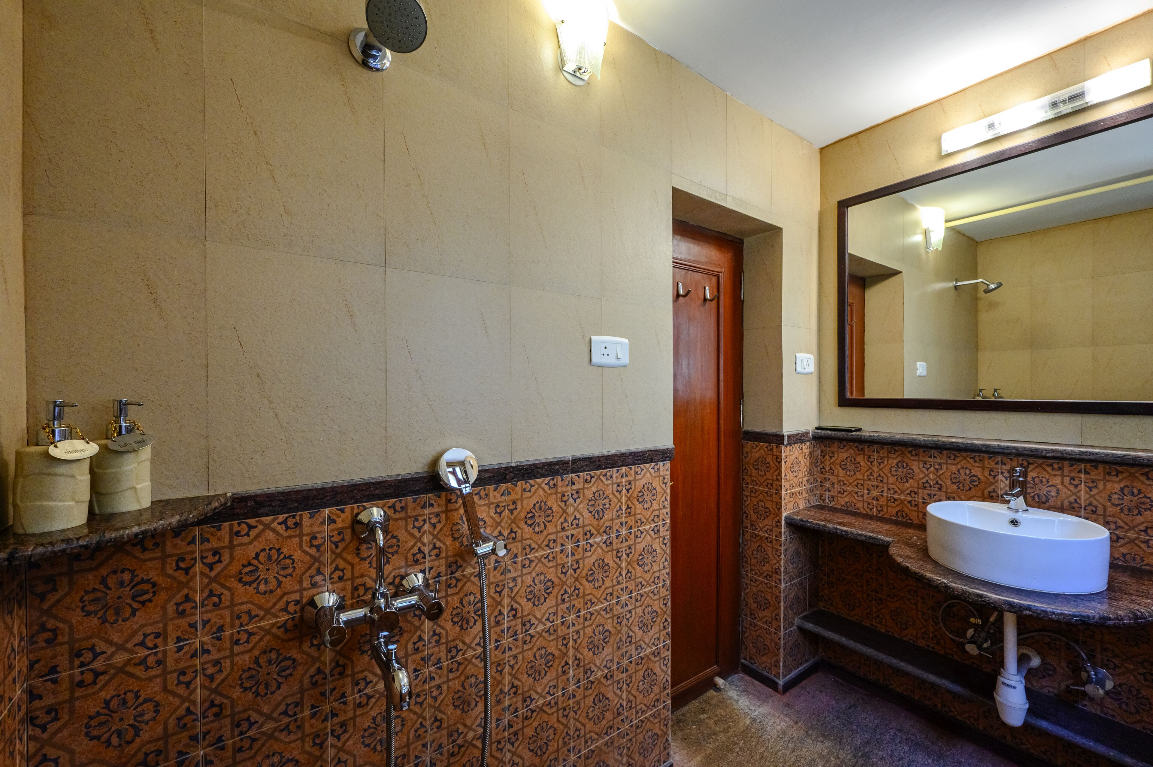 A bathroom with a shower, a sink, and a mirror.