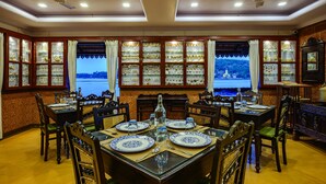 Comedor con vistas a un lago, armarios de madera con puertas de cristal y ventiladores de techo.